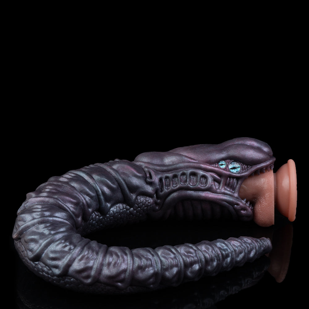 Dark sculpted arm and hand holding a cylindrical container, blue eye near thumb