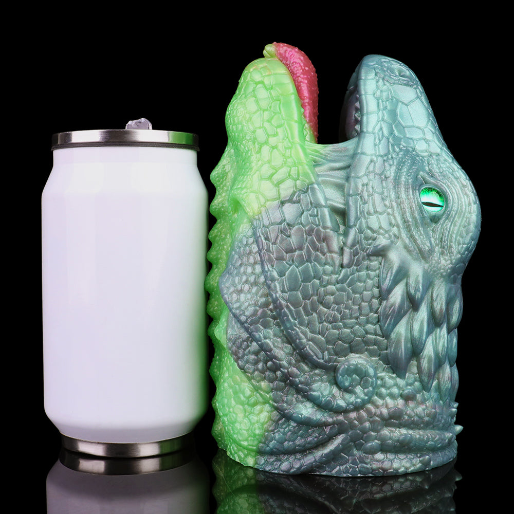 Dragon Fleshlight next to white bottle for scale, green-and-blue textured creature body