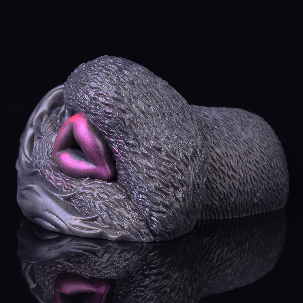 Side view with purple opening, textured dark gray dual-hole vibrating masturbator