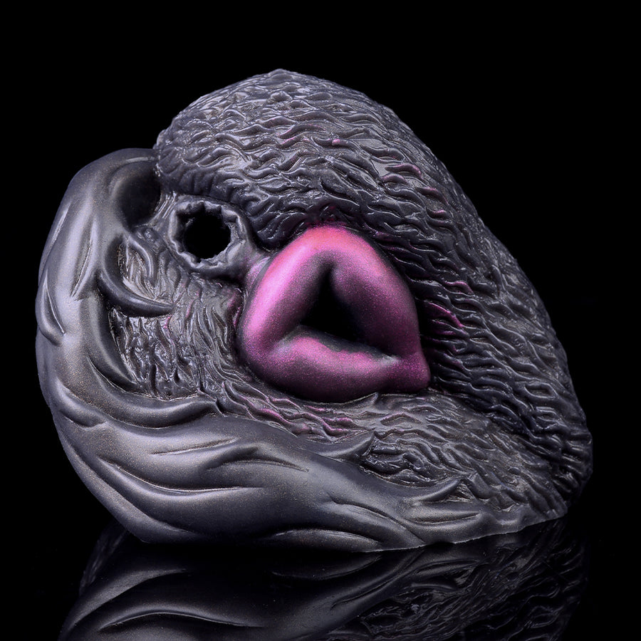 Gray animal-shaped vibrating masturbator close-up with pink insert and small opening