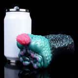 Teal alien creature stroker with pink bulb end and dark scaly exterior, angled