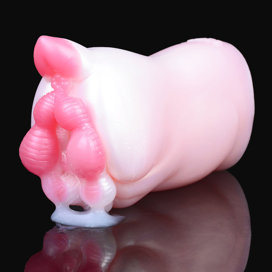 Light pink pocket masturbator with open end and magenta ribbed accents, side close-up.