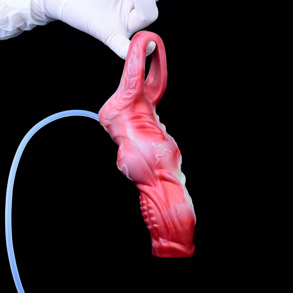 Dragon knot sheath in hand, red; tube connected for squirting