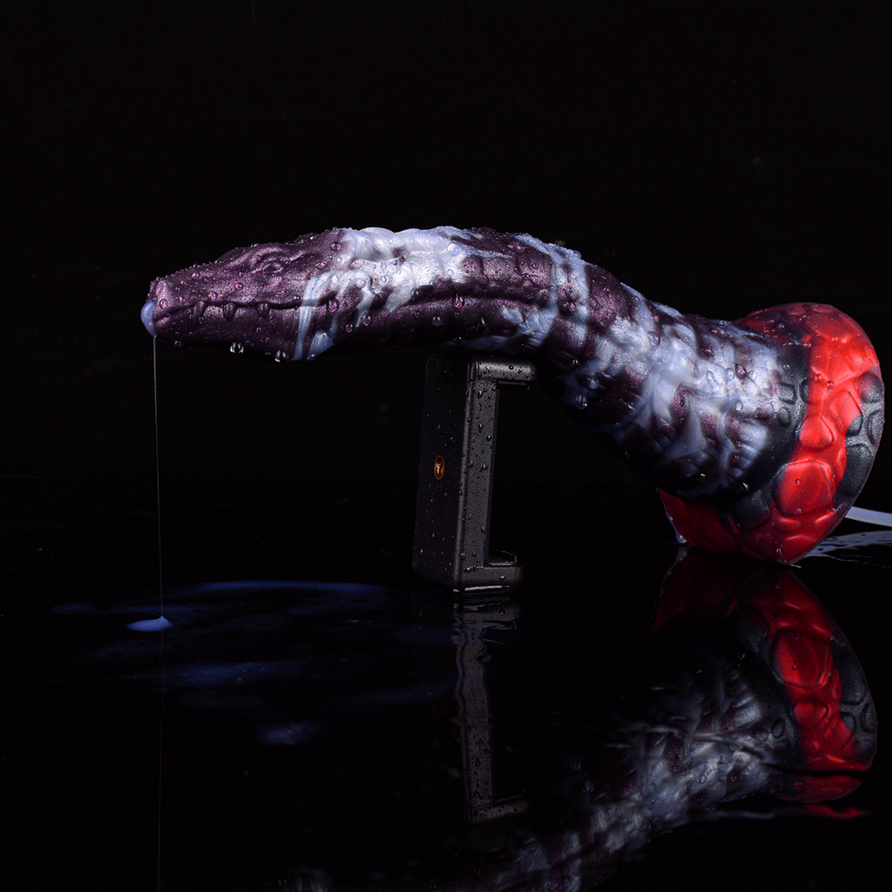 Purple-and-white dildo with red base and clear tube, dispensing toward container