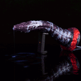 Purple-and-white dildo with red base and clear tube, dispensing toward container