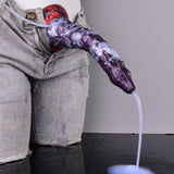 Purple-and-white reptile-pattern dildo in hand with clear tube to pink bulb