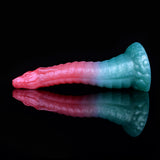 Teal-and-pink curved dildo with textured scales, tapered tip and wide flared base