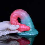 Angled pink-and-teal dildo with flared base, thick curved shaft, raised scale pattern