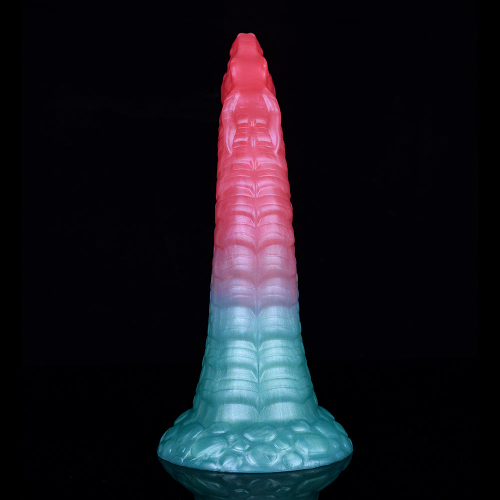 Ridged dragon-shaped butt plug with pink top, teal body, and curved base.