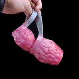 Pink ribbed knot sleeve with gray handles/loops, held by fingers