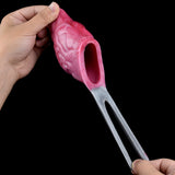 Held pink sleeve ring showing open end and gray underside loop