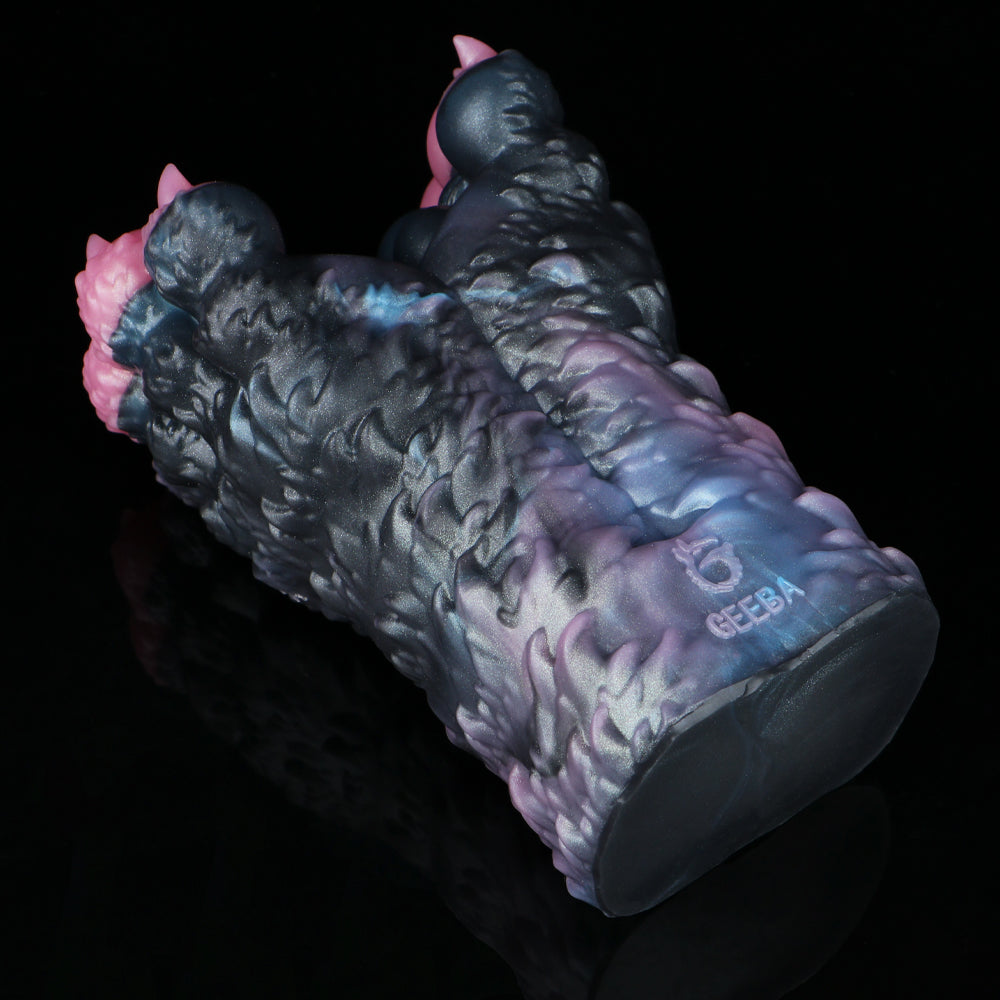 Dark blue and black textured toy with pink side bumps, side view