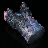 Dark blue and black textured toy with pink side bumps, side view