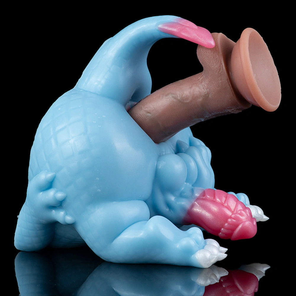 Light blue dragon toy with pink tail tip and inner sleeve, angled side view