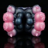Dark blue and black textured butt-shaped toy with four pink protrusions, front view