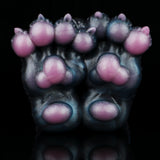 Front view of monster paw-shaped novelty toy with pink toe pads and claws