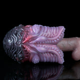 Dark purple and pink octopus-themed silicone sex toy, side view with textured tentacles