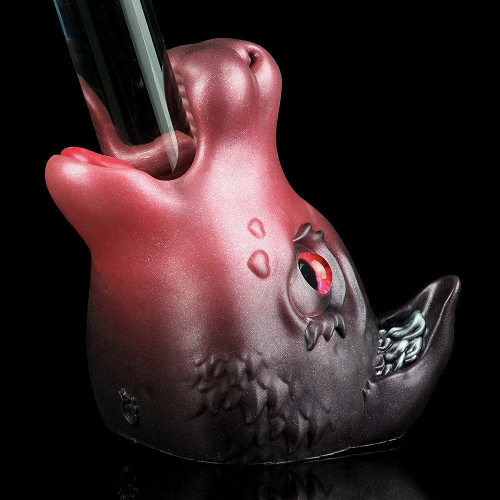 Pink and dark gray cat figurine with red glowing eyes and textured lower body