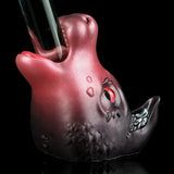 Pink and dark gray cat figurine with red glowing eyes and textured lower body