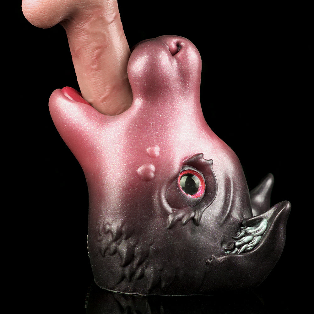Pink and dark gray cat figurine with red glowing eye and open mouth
