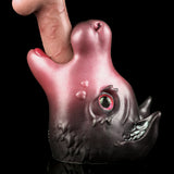 Pink and dark gray cat figurine with red glowing eye and open mouth