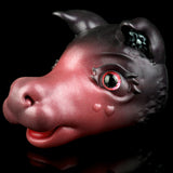 Pink and dark gray cat figurine side view with red glowing eye and snout