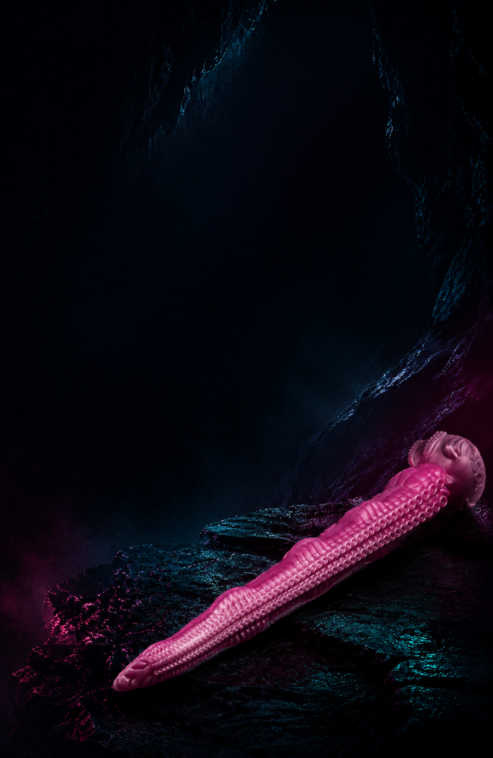 Pink fantasy tentacle dildo on a dark neon-lit cave background - DirtyToyz.com