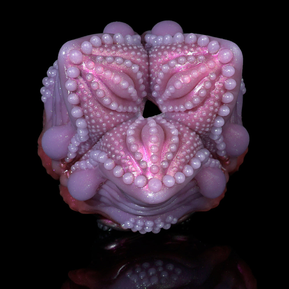 Front view pink silicone octopus-shaped sex toy with two curled arms and bead texture