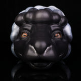 Animal figurine front view with black-and-white mane, orange eyes, rounded muzzle