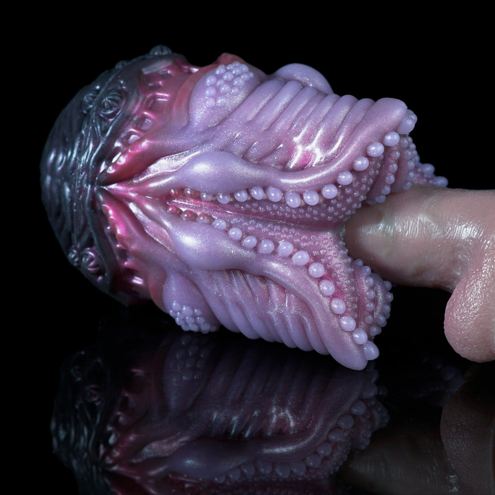 Side view pink and dark silicone octopus-shaped sex toy with wavy tentacle ridges