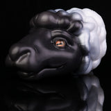 Animal figurine close-up side face, black-and-white mane, orange eye, glossy finish