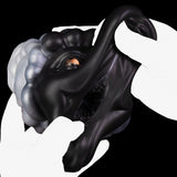 Animal figurine with black-and-white swirled mane and orange eyes, arched body pose
