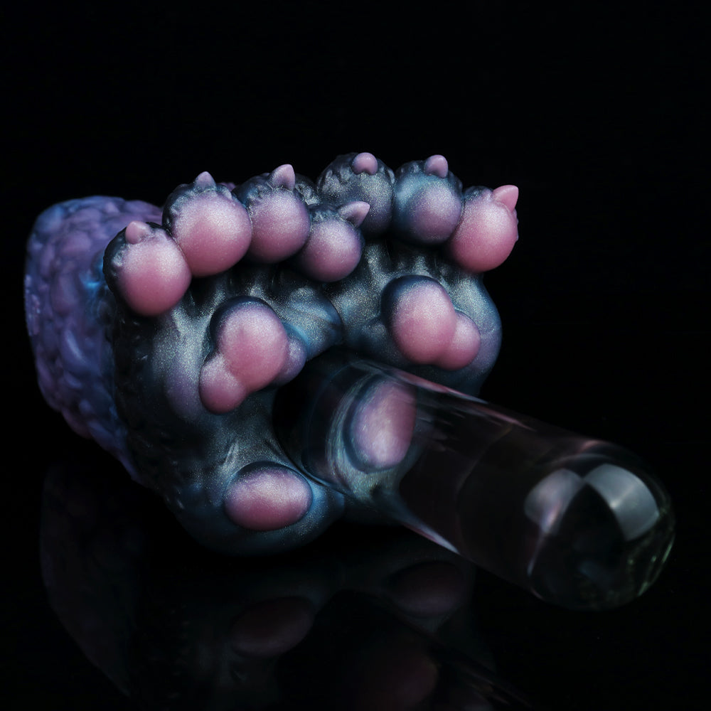 Three-quarter view of monster paw-shaped novelty toy with pink claw pads