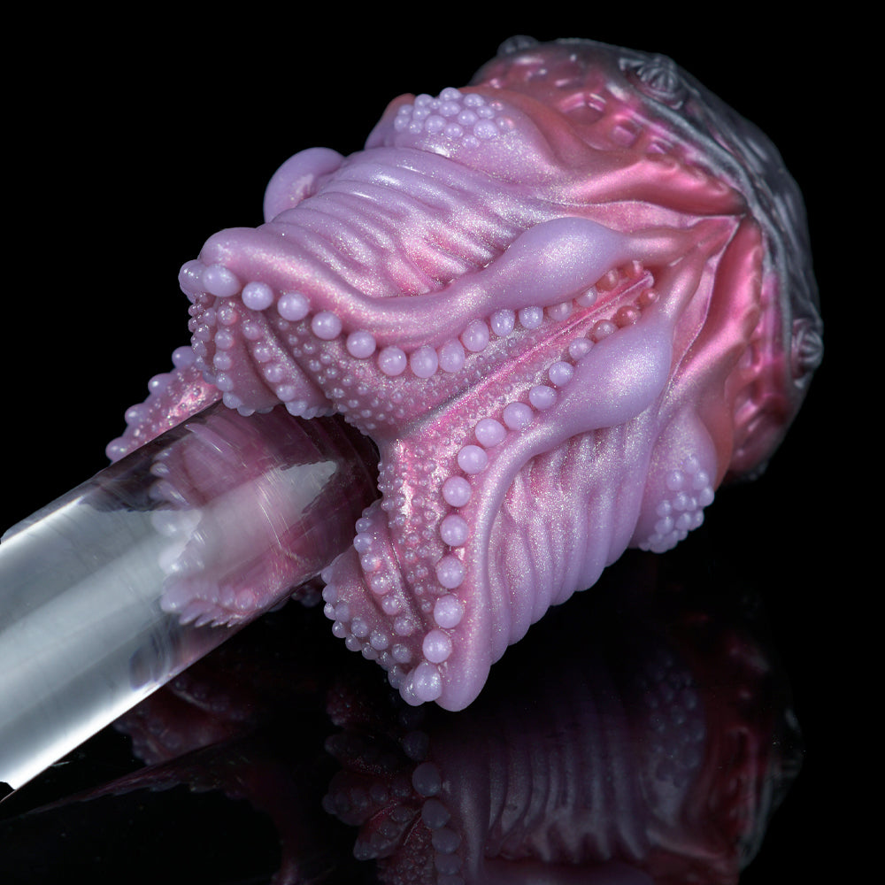 Angled view pink silicone octopus-shaped sex toy with bead-studded tentacles