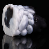 Animal figurine close-up of swirled mane, glossy black and white tones, partial orange eye