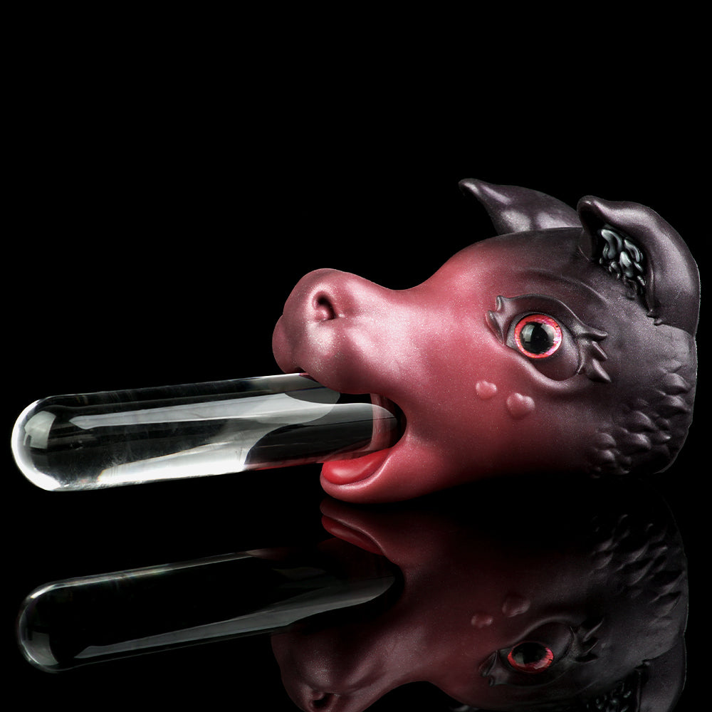 Pink and dark gray cat figurine with red glowing eyes and open mouth