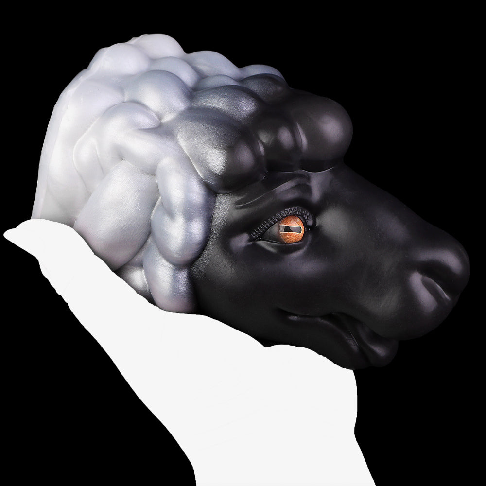 Animal figurine side view with black-and-white mane and orange eye, smooth rounded muzzle