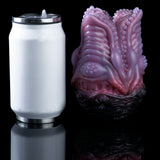 White cylindrical canister with metal lid and purple hand-shaped resin piece