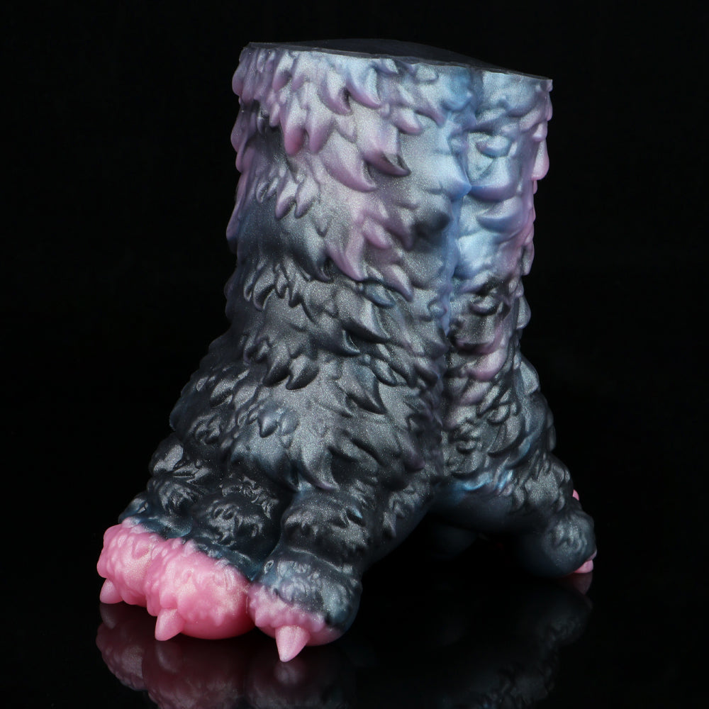 Dark blue and black textured toy with pink base edge and side nubs, angled