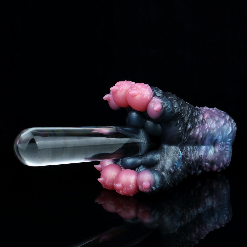 Dark blue and black textured toy with pink bumps and transparent end, side view
