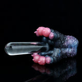 Dark blue and black textured toy with pink bumps and transparent end, side view