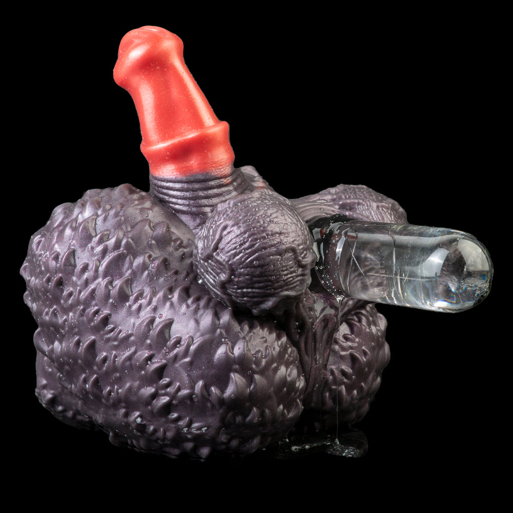 Purple textured hand-shaped toy with red horn and transparent tube-like piece on side.