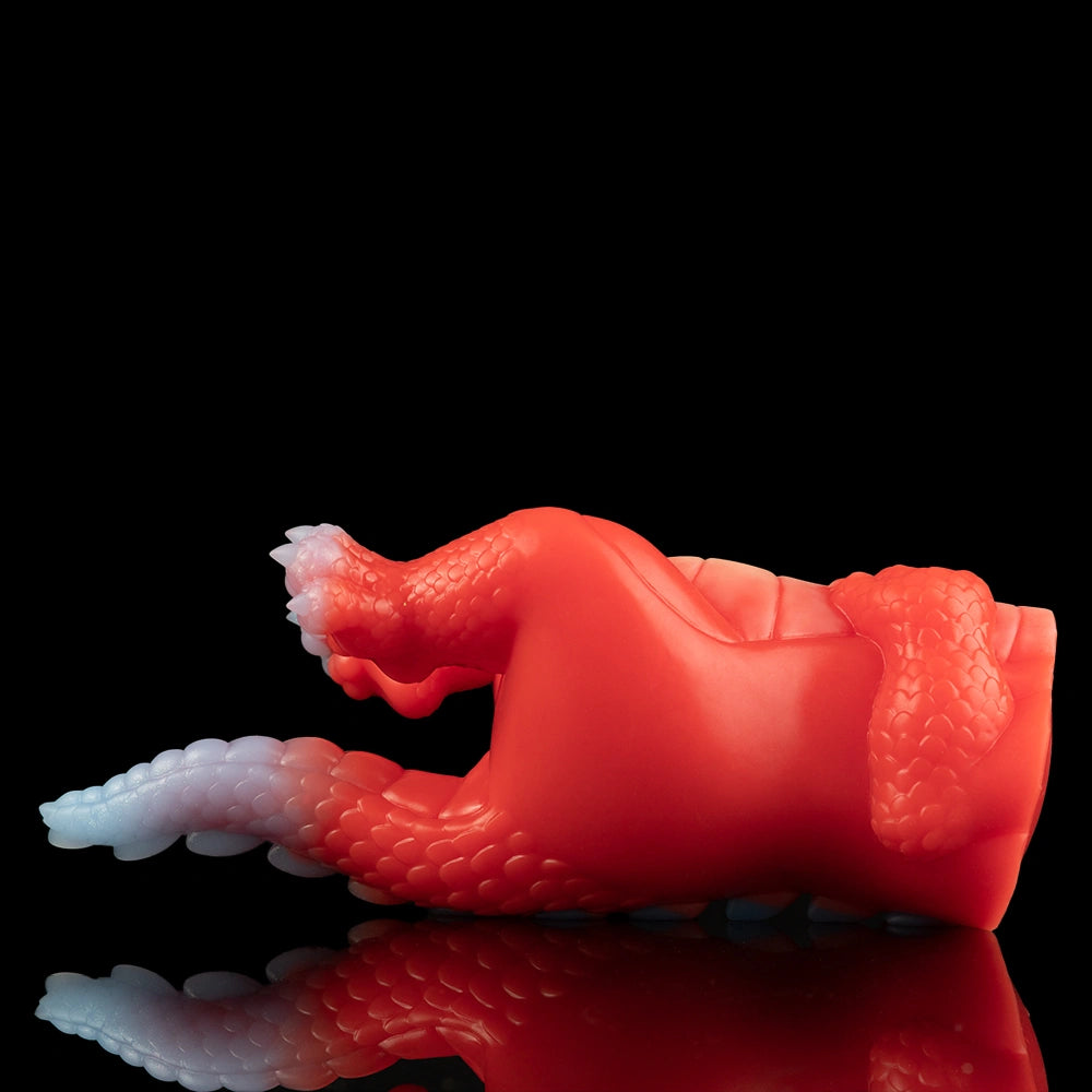 Red dragon fantasy sex toy shown from side with wing fins and curled lower body