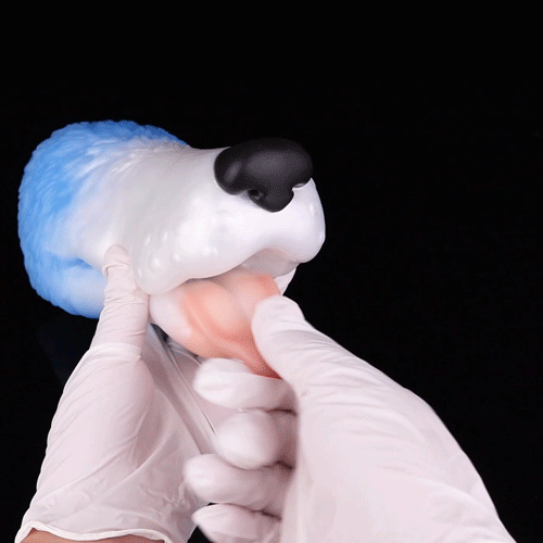 Dog-shaped toy held in gloved hands, white body with light blue back and black snout