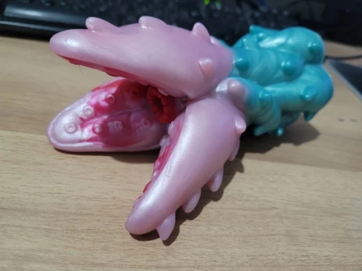 Customer photo of pink and turquoise Tentaclite fantasy Fleshlight monster strokers for men featuring soft silicone, raised creature textures and detailed fantasy male masturbator designs