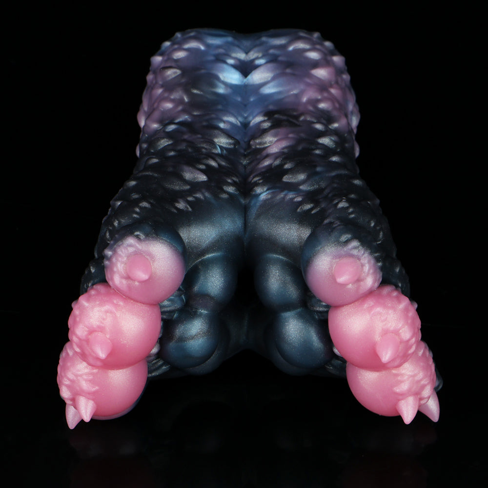Dark blue and black textured butt-shaped toy with pink protrusions at the sides