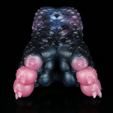 Dark blue and black textured butt-shaped toy with pink protrusions at the sides