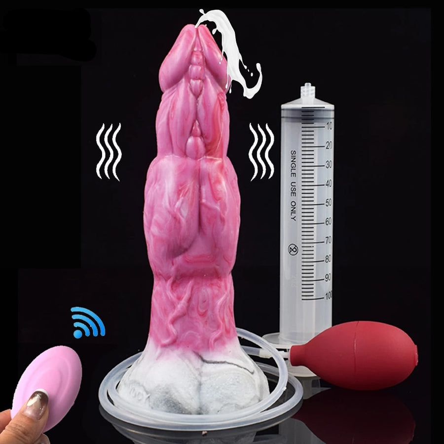 Pink monster-shaped vibrator with remote controller, cable, and measuring cylinder