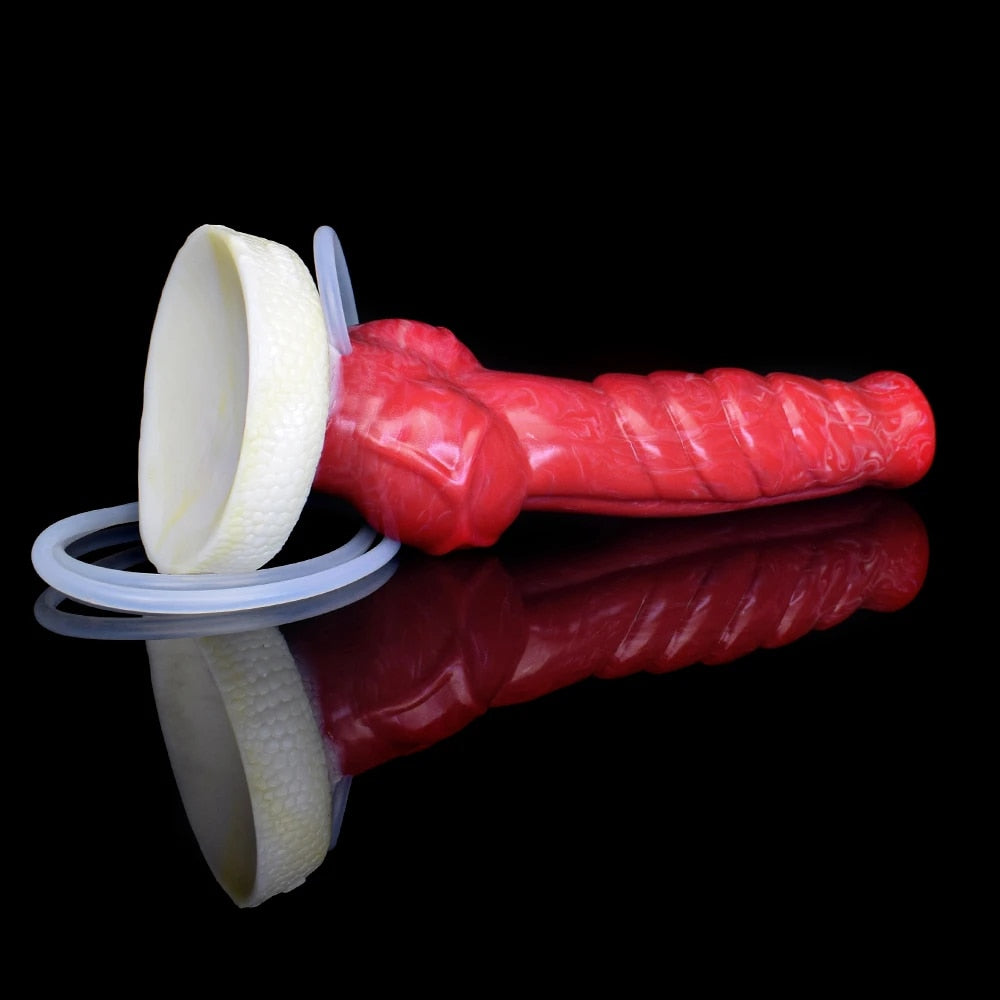 Red textured dildo with large white base ring and two loops of clear tube