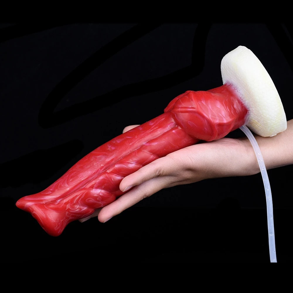 Red textured dildo with white base and clear tube held in hand